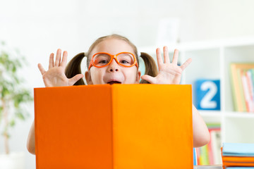 Wall Mural - funny kid girl weared eyeglasses with book