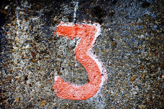 different numbers written in paint on the wall
