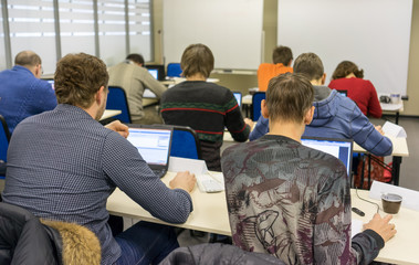 people sitting rear at the computer training class