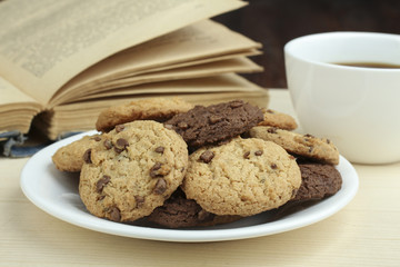 Wall Mural - cookies and cup of hot coffee on wooden table