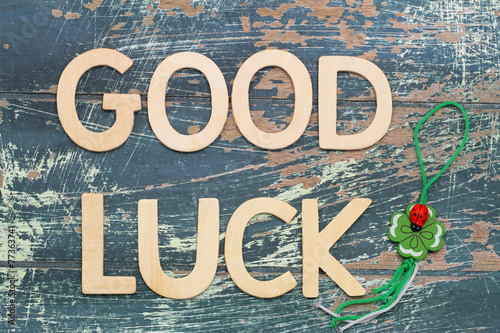 Fotografia Good luck written with wooden letters and four-leaf clover