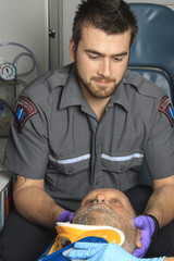 Wall Mural - professional paramedics giving unconscious young woman first aid