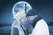 Smiling Couple In Winter Fashion Posing With Roses