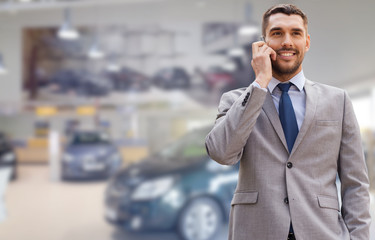 Wall Mural - smiling businessman talking on smartphone