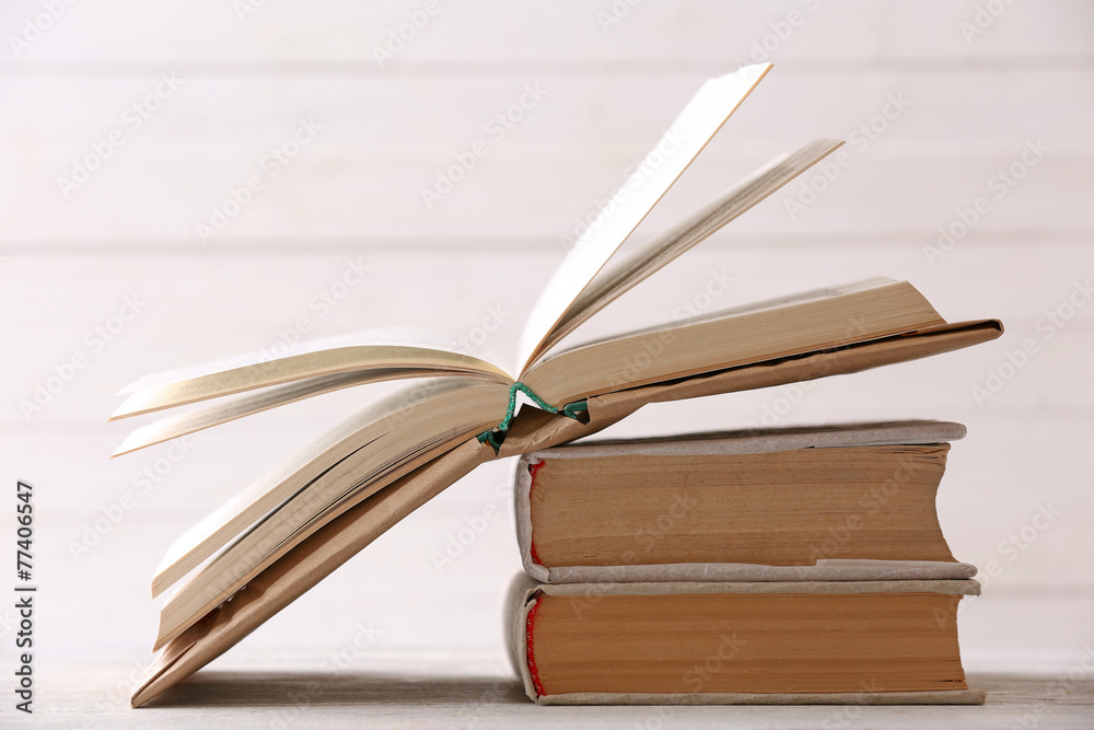 Stack of books on color wooden planks background