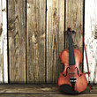 Violin leaning on a wooden fence. Room for text or copy space.