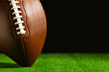 American Football On Green Grass, On Black Background