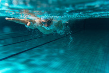Male Swimmer At The Swimming Pool.Underwater Photo.