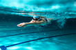 Leinwandbild Motiv Female swimmer at the swimming pool.Underwater photo.