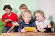 © Kekyalyaynen - All family, kids and parents sit in gadgets, play game in phone