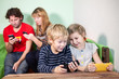 © Kekyalyaynen - Children and parents playing games on smartphones