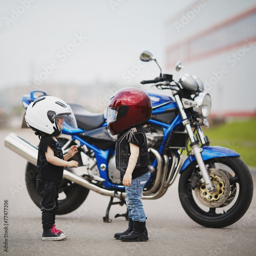 Fototapeta na wymiar little bikers on road with motorcycle