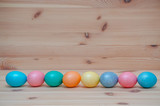 Fototapeta  - happy easter eggs pastel colored on the wooden background