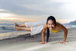 © TinPong - Beautiful woman yoga on the beach.