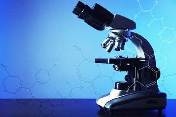 Wall Mural - microscope on table, on blue background
