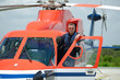 offshore helicopter pilot is standing on helicopter cockpit