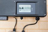 Fototapeta  - Photovoltaic inverter installed in a home