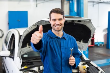 Poster - Smiling mechanic looking at camera