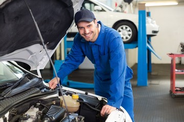 Poster - Mechanic examining under hood of car