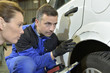 Mechanician with insurance adjuster checking on auto repair