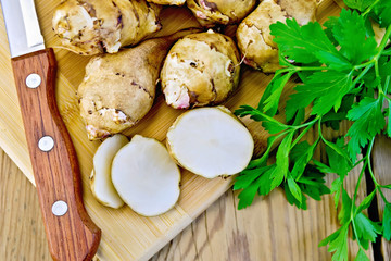 Poster - Jerusalem artichokes cut with knife and parsley on board