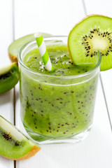 Wall Mural - kiwi smoothie in a glass on wooden surface