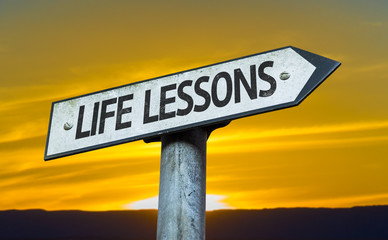 Life Lessons sign with a sunset background