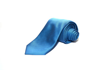 Folded blue tie on a white background