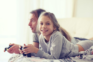 Canvas Print - Child playing video game with father