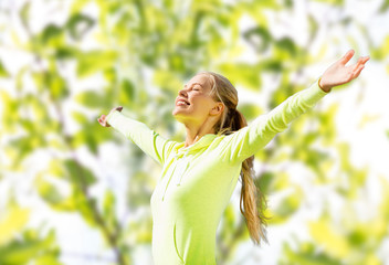 happy woman in sport clothes raising hands