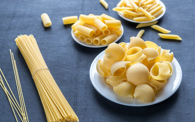 Canvas Print - Various types of pasta on the dark background