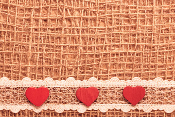 Wall Mural - Red hearts on abstract cloth background