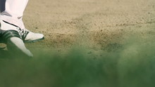 Golfer On A Sand Golf Course Hitting The White Golf Ball