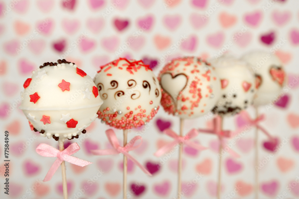 Tasty cake pops on color background