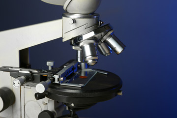 Wall Mural - microscope on table, on color background