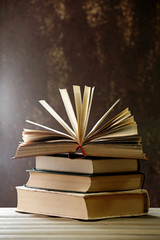 Wall Mural - Books with light over dark background