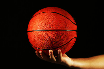 Poster - Basketball player holding ball, on dark background