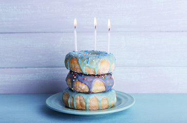 Wall Mural - Delicious donuts with icing and birthday candles