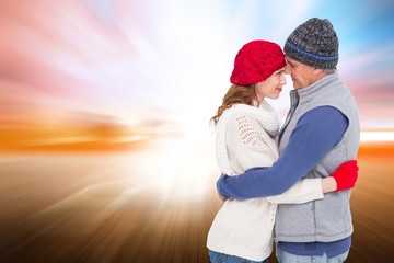 Poster - Composite image of happy couple in warm clothing hugging