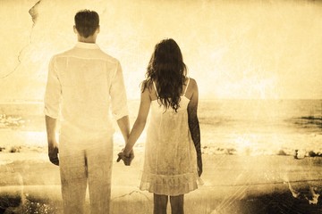 Aufkleber - Attractive couple holding hands and watching the ocean