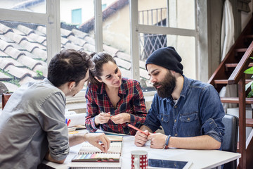 Teamwork. Three young architects working on a project