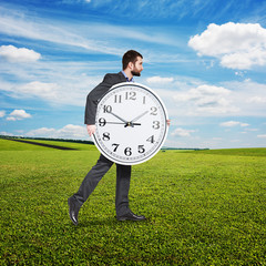 Canvas Print - businessman holding big clock