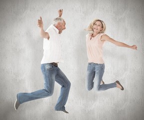 Poster - Composite image of excited couple cheering and jumping