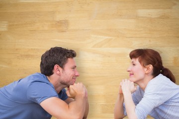 Poster - Composite image of couple lying on the floor