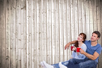 Aufkleber - Composite image of couple having tea on floor