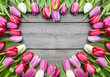 tulips arranged on old wooden background
