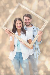 Aufkleber - Composite image of happy young couple holding picture frame