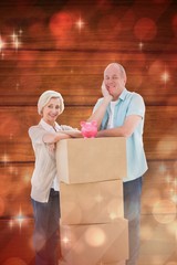 Poster - Older couple smiling at camera with moving boxes