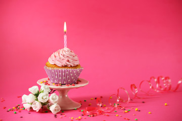 Wall Mural - Delicious cupcake on table on pink background