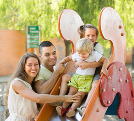 Wall Mural - Family playing at children's slide